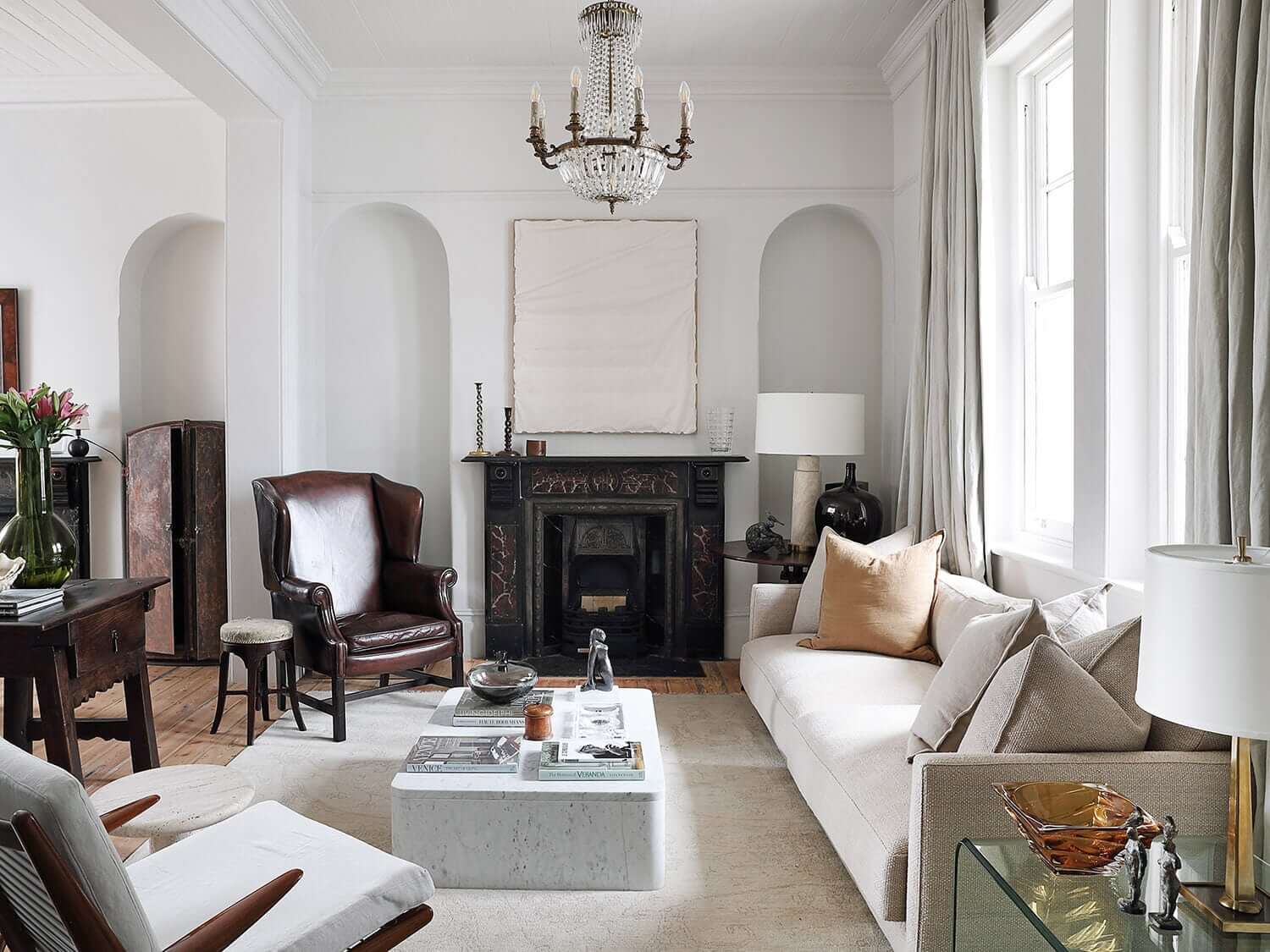 Sophisticated living room with fireplace and carpet over the wooden floor, photograph by Elsa Young
