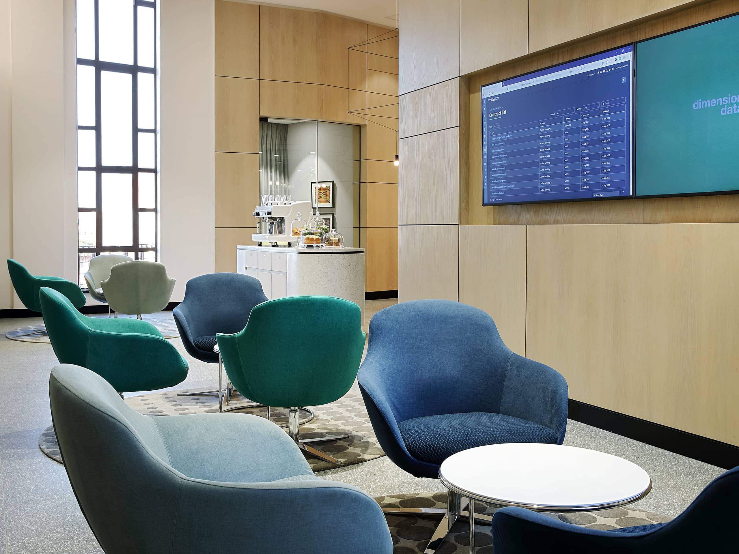 Modern airport members' lounge with comfortable armchairs and food station. Elsa Young Photography.